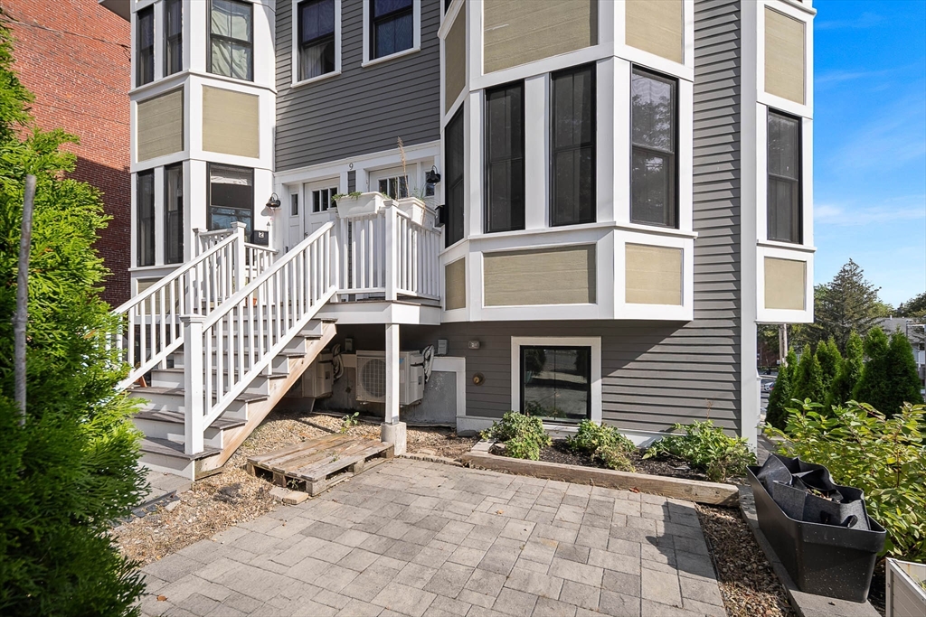 9 Cedar Street, Unit 1 Boston, MA 02119 - Photo 2 of 25 a view of a brick building with plants and windows