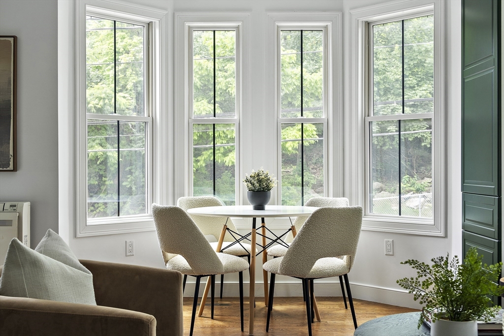 9 Cedar Street, Unit 1 Boston, MA 02119 - Photo 8 of 25 a view of a dining room with furniture window and outside view