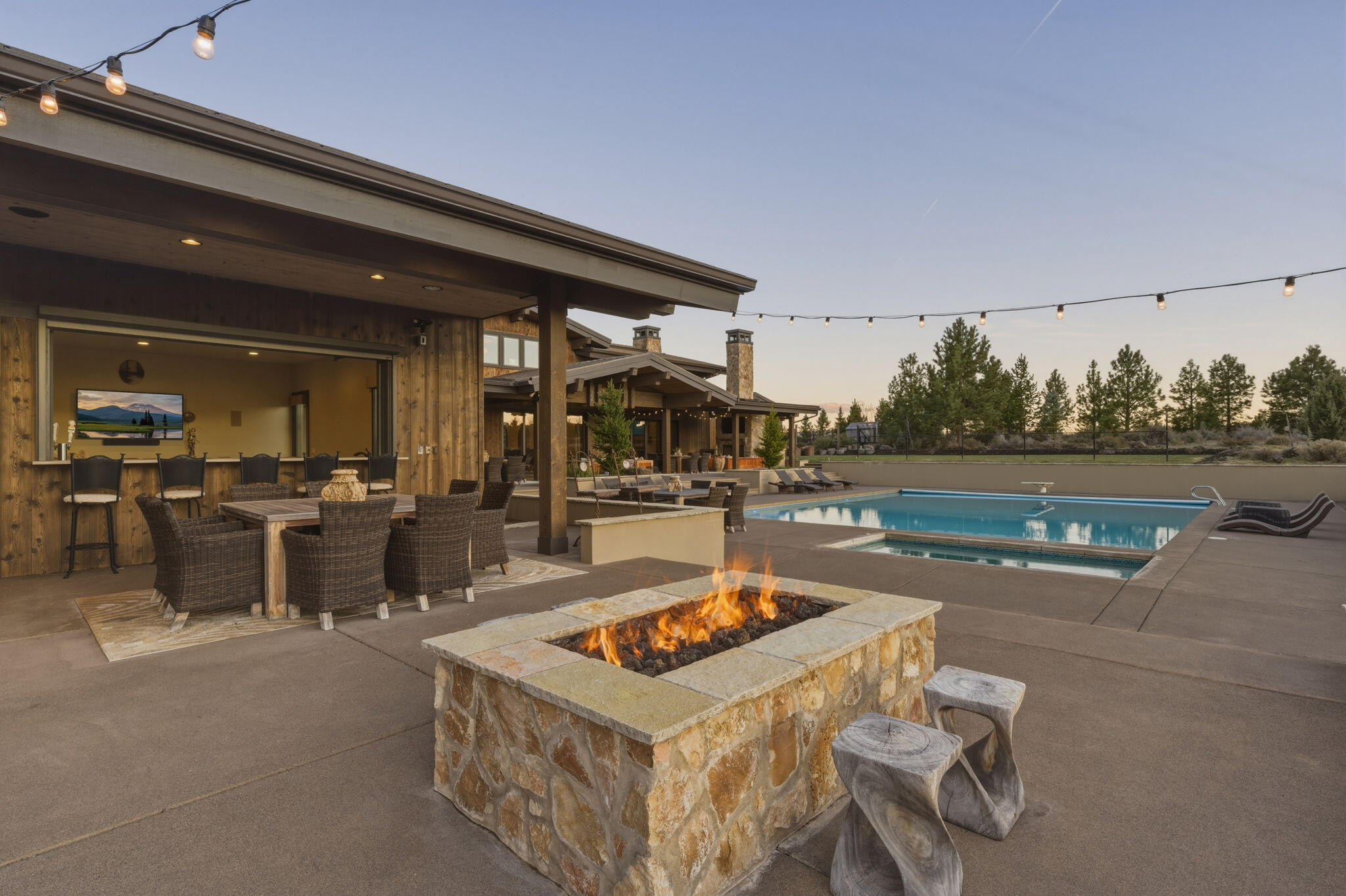 19100 Macalpine Loop Bend, OR 97702 - Photo 41 of 56 Outdoor living with firepit - views of pool and poolhouse