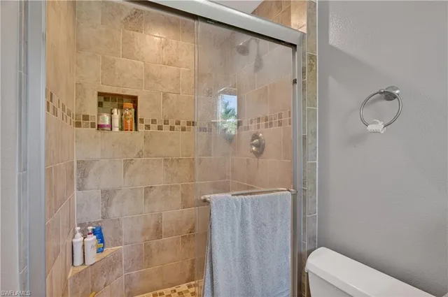 a bathroom with a shower and toilet
