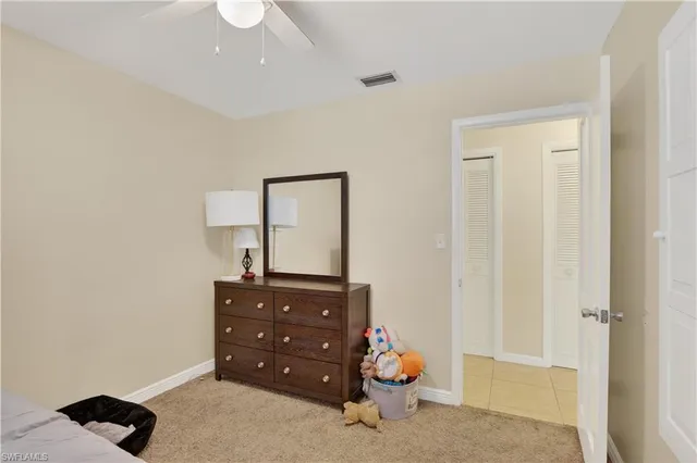 a room with a baby crib and dresser