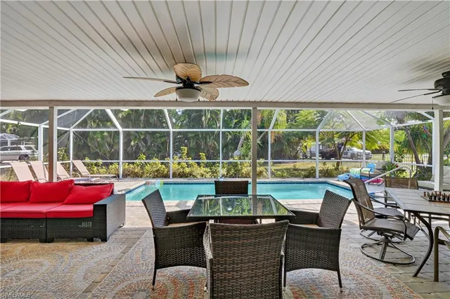 a view of a porch with furniture and a yard