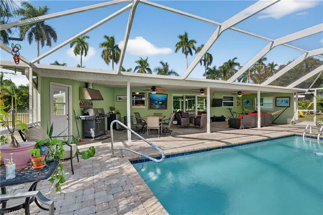 a view of a house with a swimming pool and sitting area