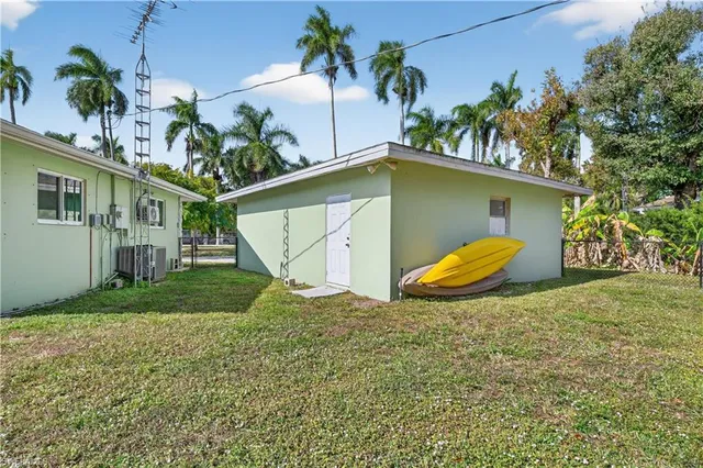a view of a house with a yard and potted plants
