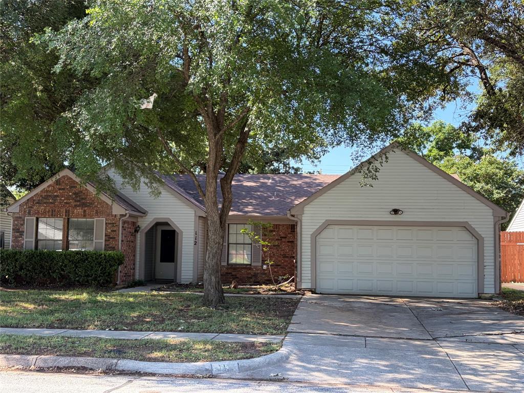 112 Cinnamon Lane Euless, TX 76039 - Photo 1 of 12 a front view of a house with garden