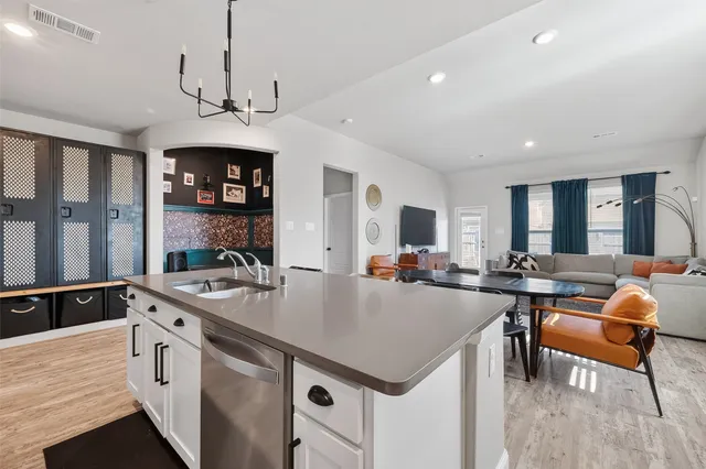 a open kitchen with stainless steel appliances granite countertop a sink a stove and a refrigerator