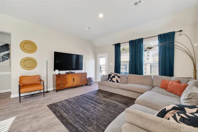 a living room with furniture and a flat screen tv
