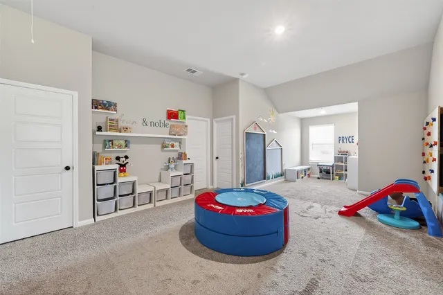 a room with a bed and gym equipment