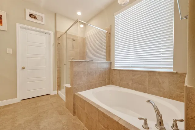 a bathroom with a tub and shower