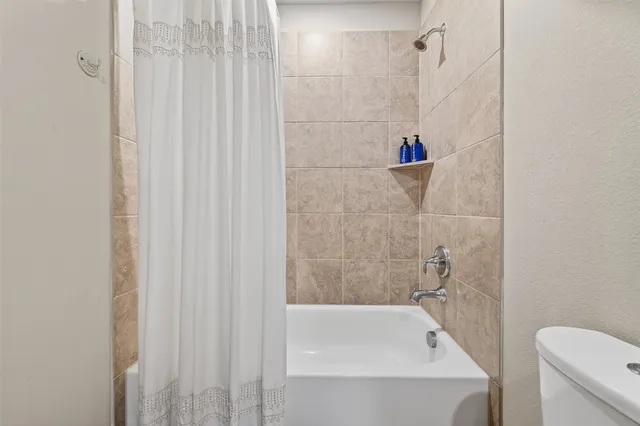 a bathroom with a bathtub and a toilet