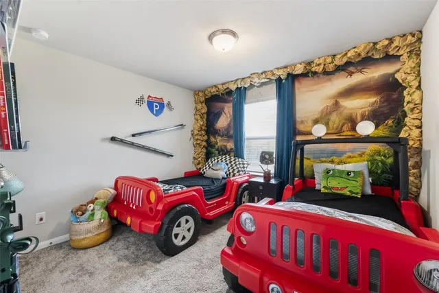 a bedroom with furniture and a window