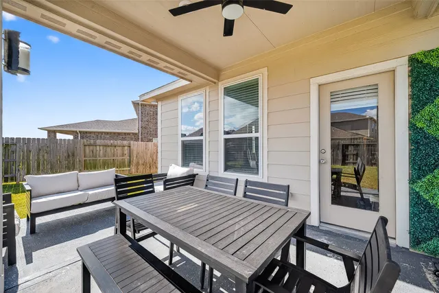 a view of a patio with table and chairs and wooden floor