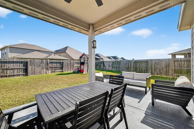 a view of a patio with couches chairs and potted plants