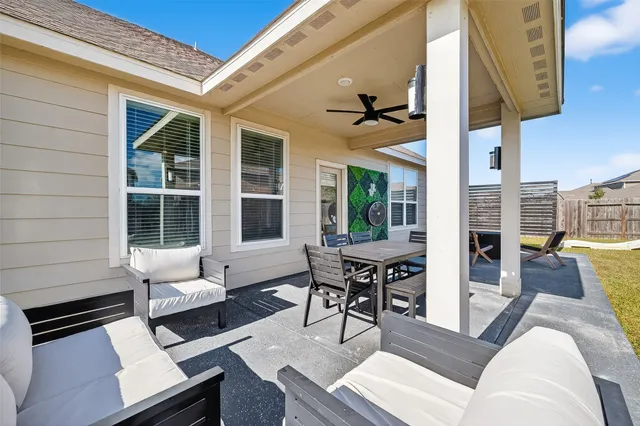 a view of a house with swimming pool and sitting area