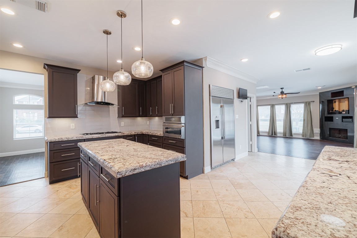 20615 Gable Ridge Drive Katy, TX 77450 - Photo 16 of 42 a kitchen with a refrigerator a sink and a wooden floor