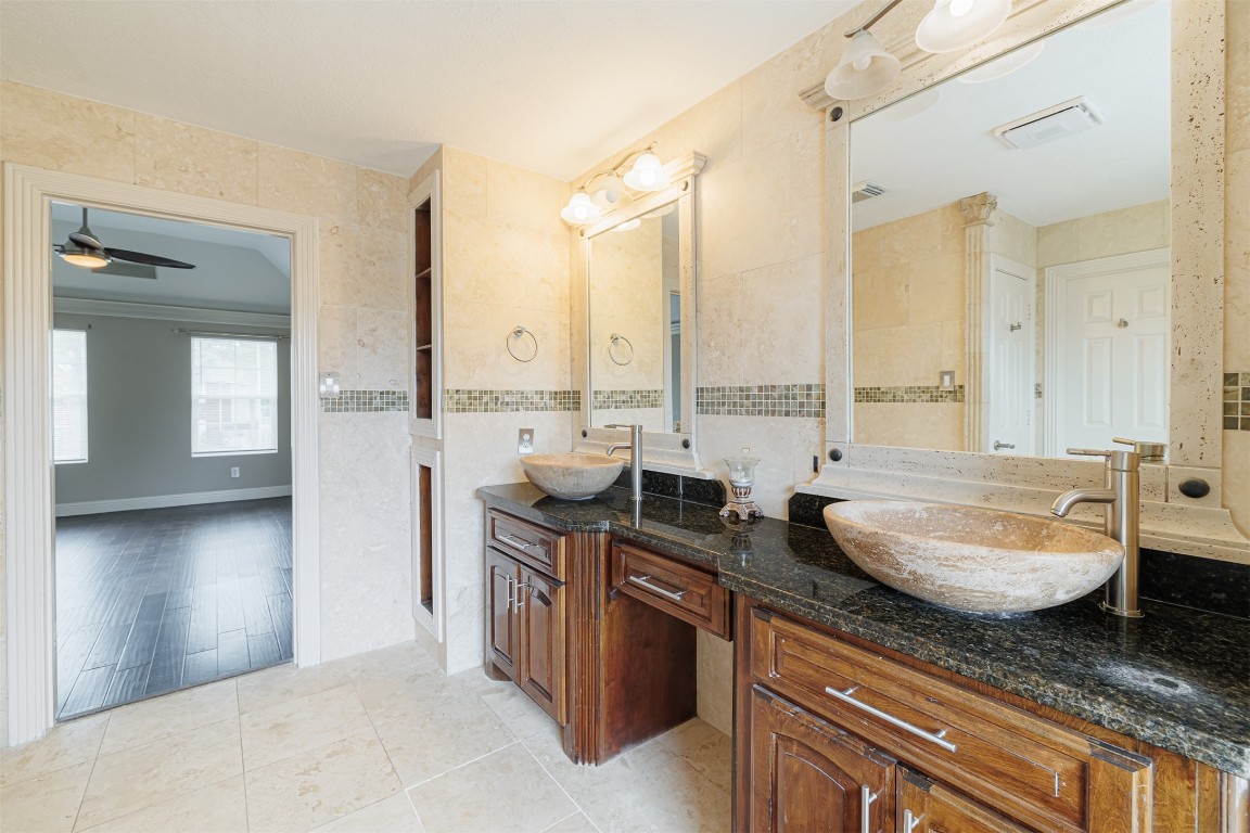 20615 Gable Ridge Drive Katy, TX 77450 - Photo 26 of 42 a spacious bathroom with a granite countertop sink and a mirror