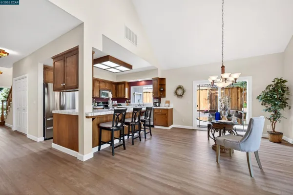a view of a house with backyard sitting area and garden