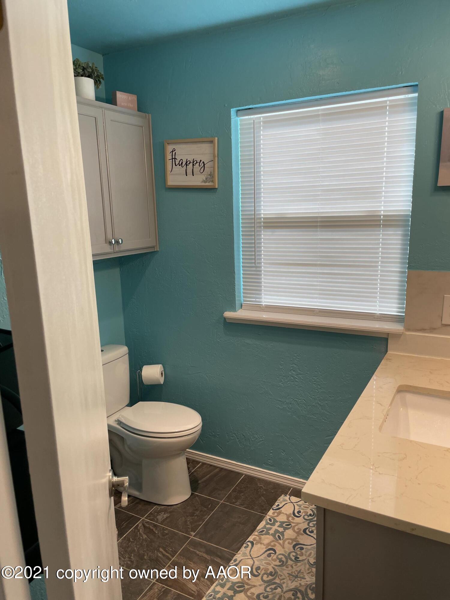 6101 Shawnee Trail Amarillo, TX 79109 - Photo 11 of 20 a bathroom with a toilet and a sink