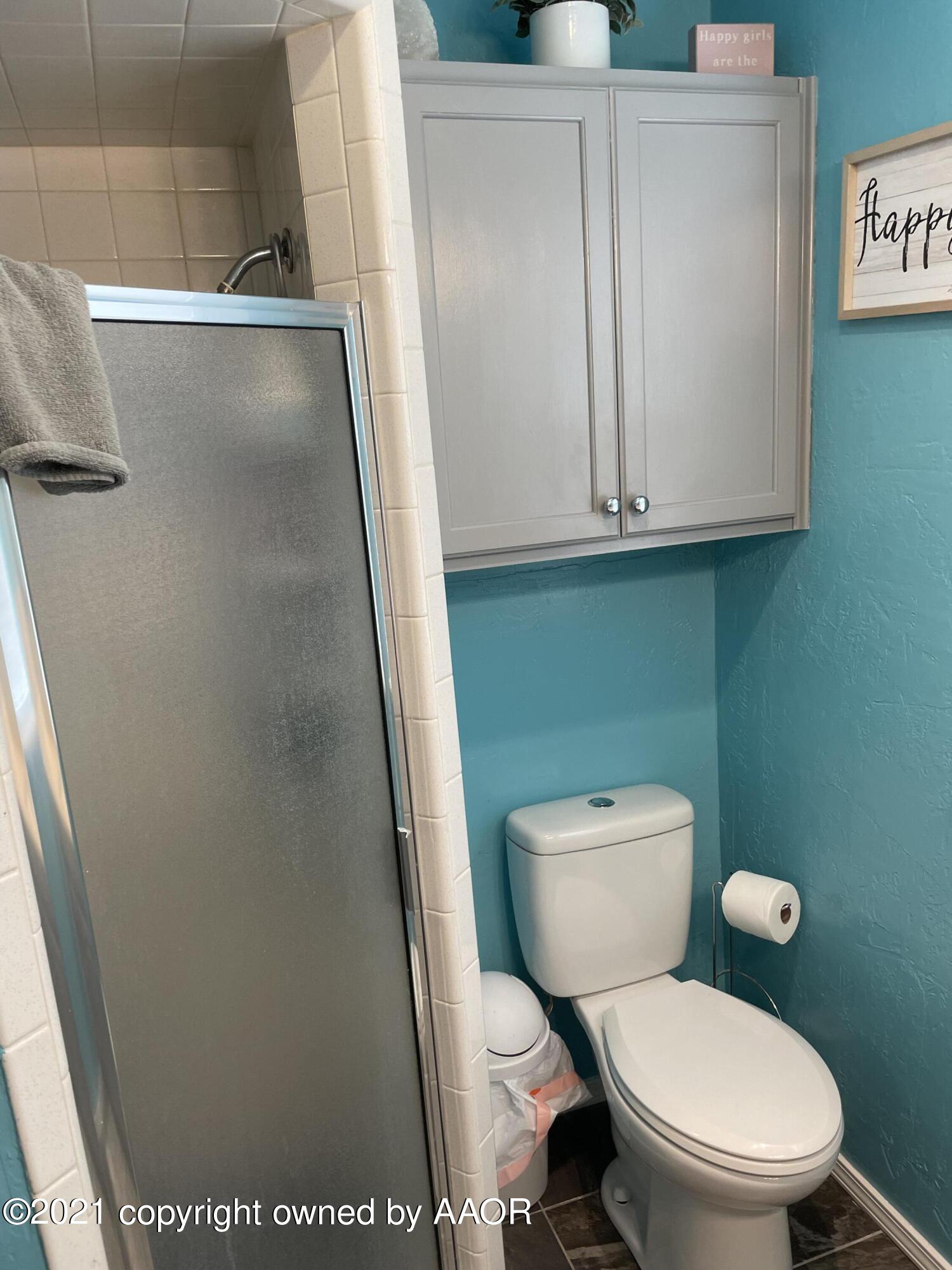 6101 Shawnee Trail Amarillo, TX 79109 - Photo 12 of 20 a white toilet sitting next to a shower