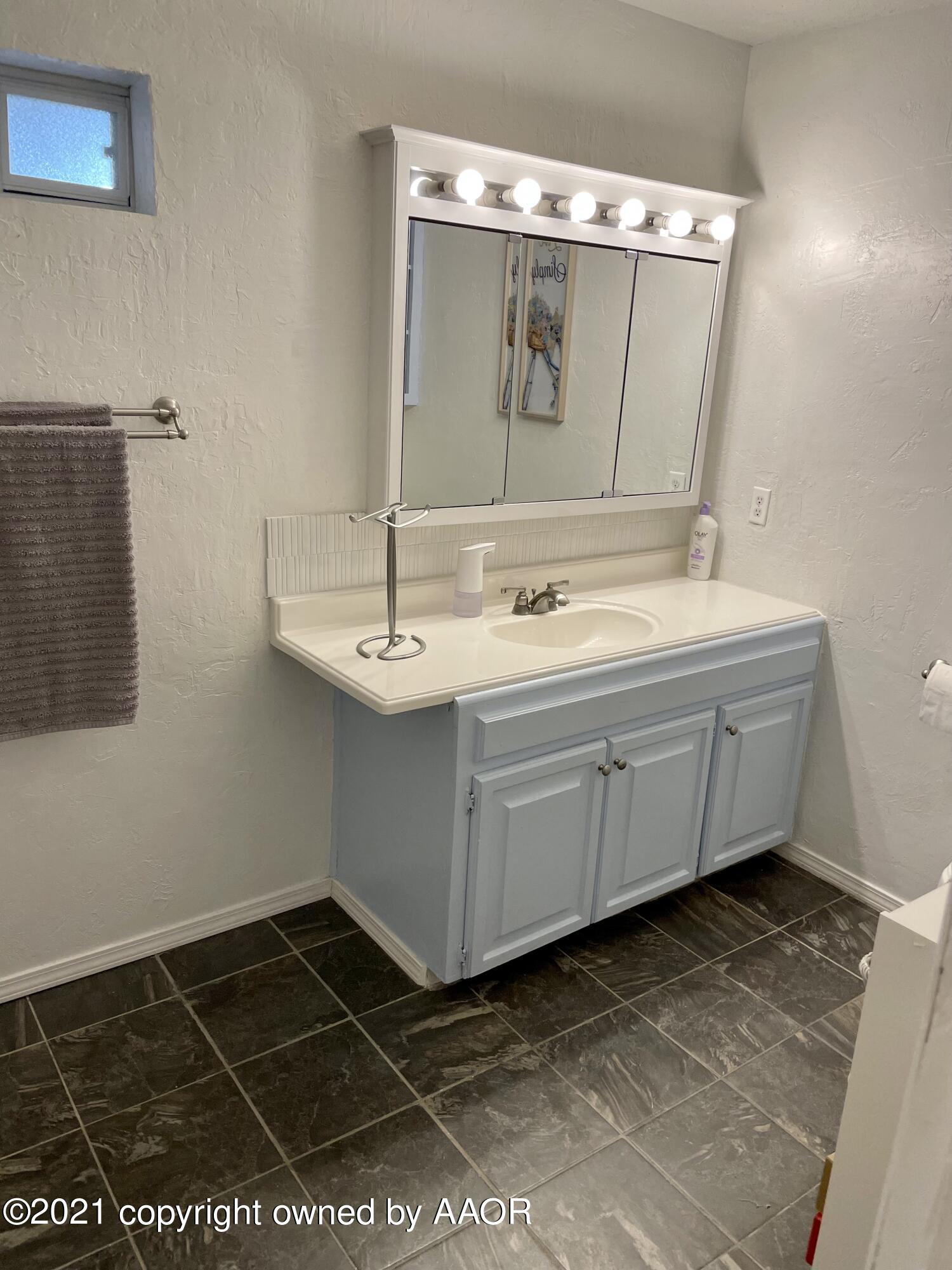 6101 Shawnee Trail Amarillo, TX 79109 - Photo 15 of 20 a bathroom with a sink and a mirror