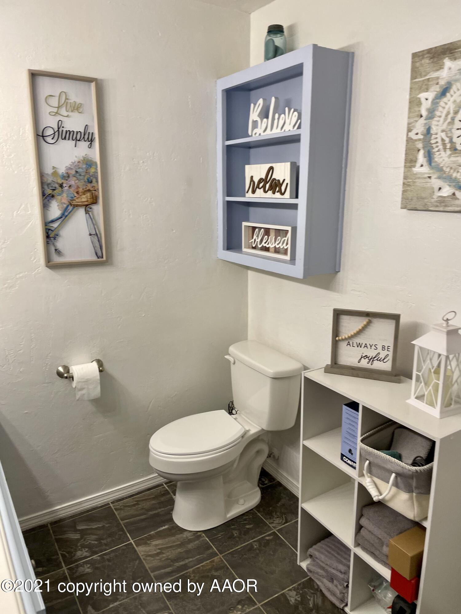 6101 Shawnee Trail Amarillo, TX 79109 - Photo 16 of 20 a bathroom with a toilet and a shower