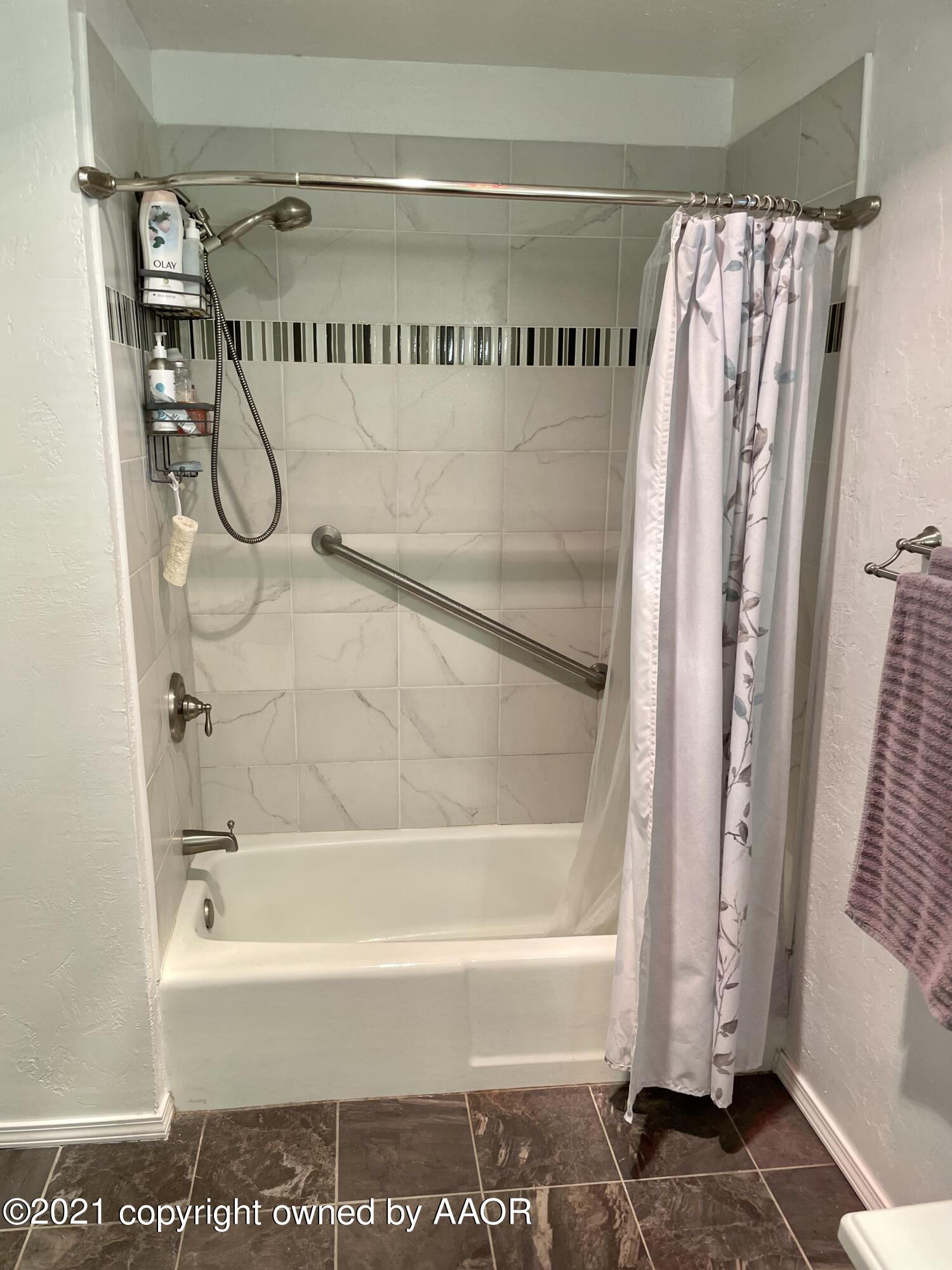 6101 Shawnee Trail Amarillo, TX 79109 - Photo 17 of 20 a bathroom with a shower and a bath tub