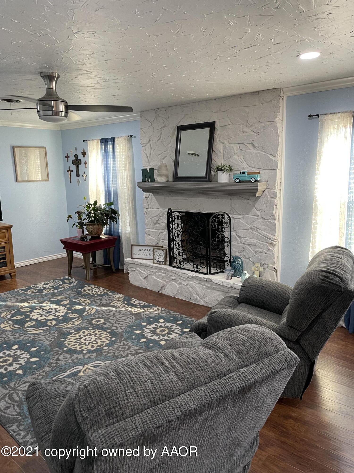 6101 Shawnee Trail Amarillo, TX 79109 - Photo 5 of 20 a living room with furniture and a fireplace