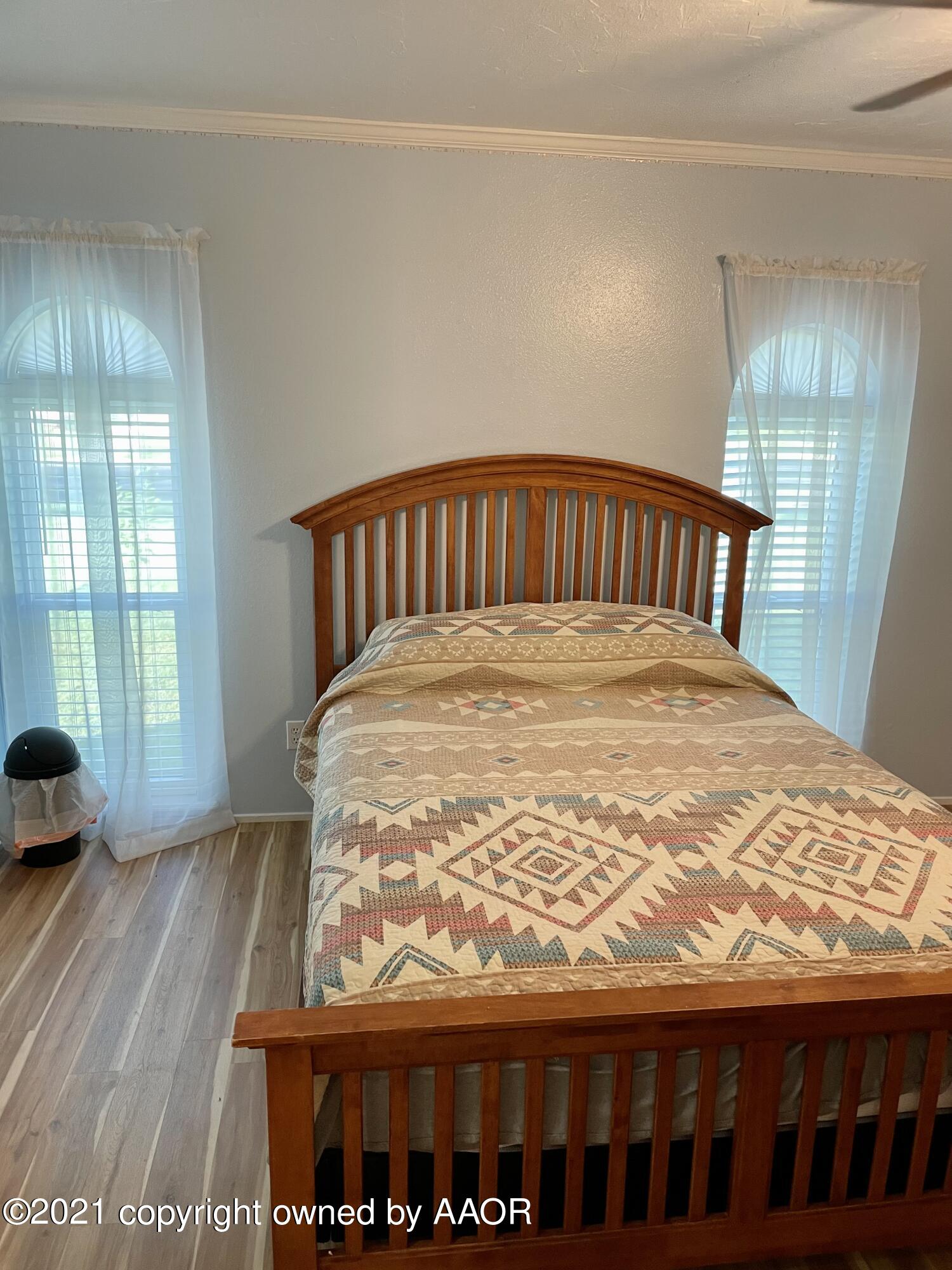 6101 Shawnee Trail Amarillo, TX 79109 - Photo 9 of 20 a large bed sitting in a bedroom next to a window