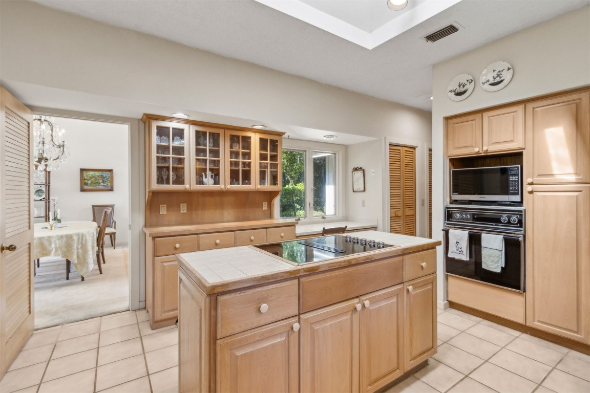 75 Marsh Creek Road Fernandina Beach, FL 32034 - Photo 14 of 42 a kitchen with a stove a sink and a refrigerator