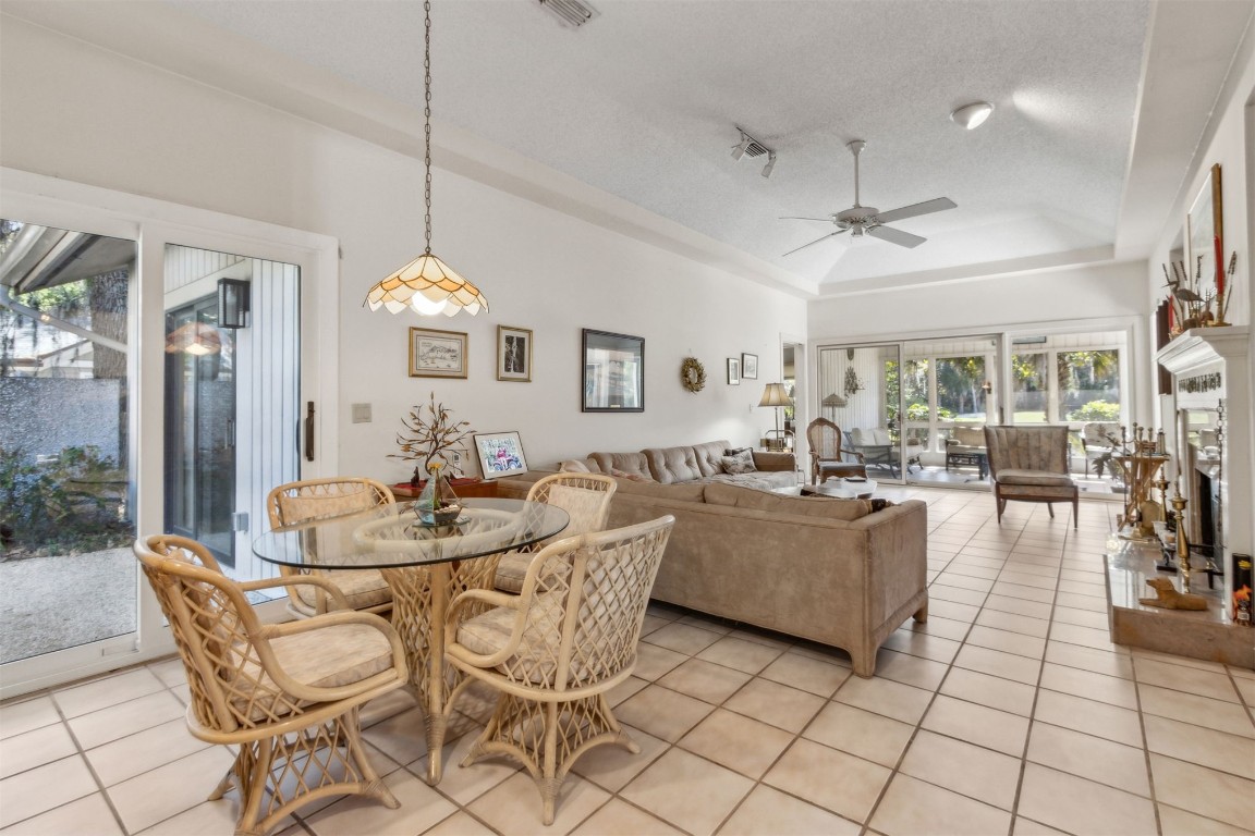 75 Marsh Creek Road Fernandina Beach, FL 32034 - Photo 15 of 42 a dining room with furniture a chandelier and kitchen view