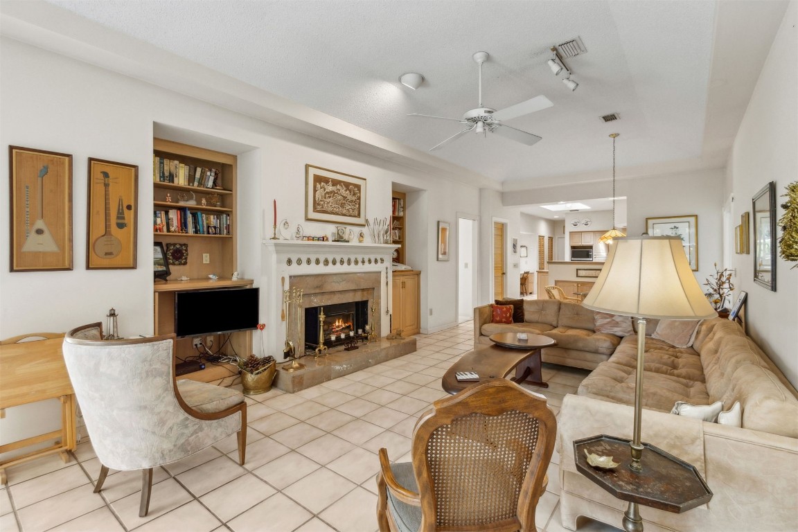 75 Marsh Creek Road Fernandina Beach, FL 32034 - Photo 18 of 42 a living room with furniture a flat screen tv and a fireplace
