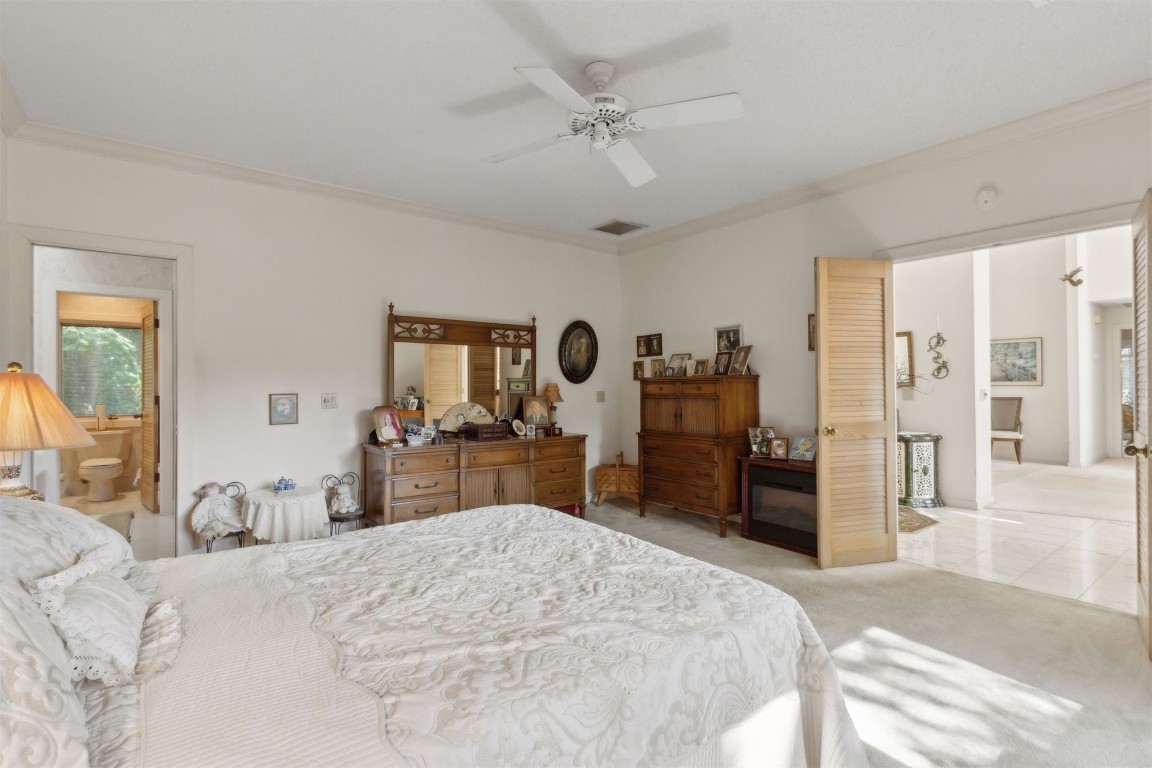 75 Marsh Creek Road Fernandina Beach, FL 32034 - Photo 22 of 42 a bedroom with a large bed and dresser