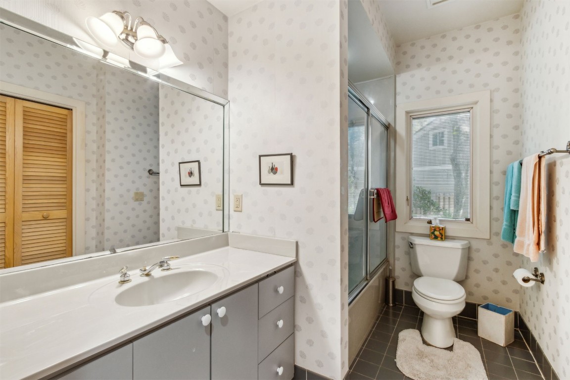 75 Marsh Creek Road Fernandina Beach, FL 32034 - Photo 27 of 42 a bathroom with a toilet a sink and a large mirror