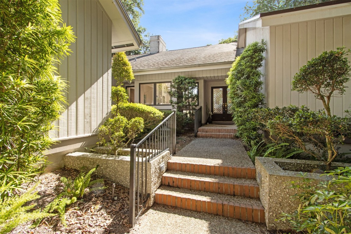 75 Marsh Creek Road Fernandina Beach, FL 32034 - Photo 3 of 42 a view of a house with large windows and plants