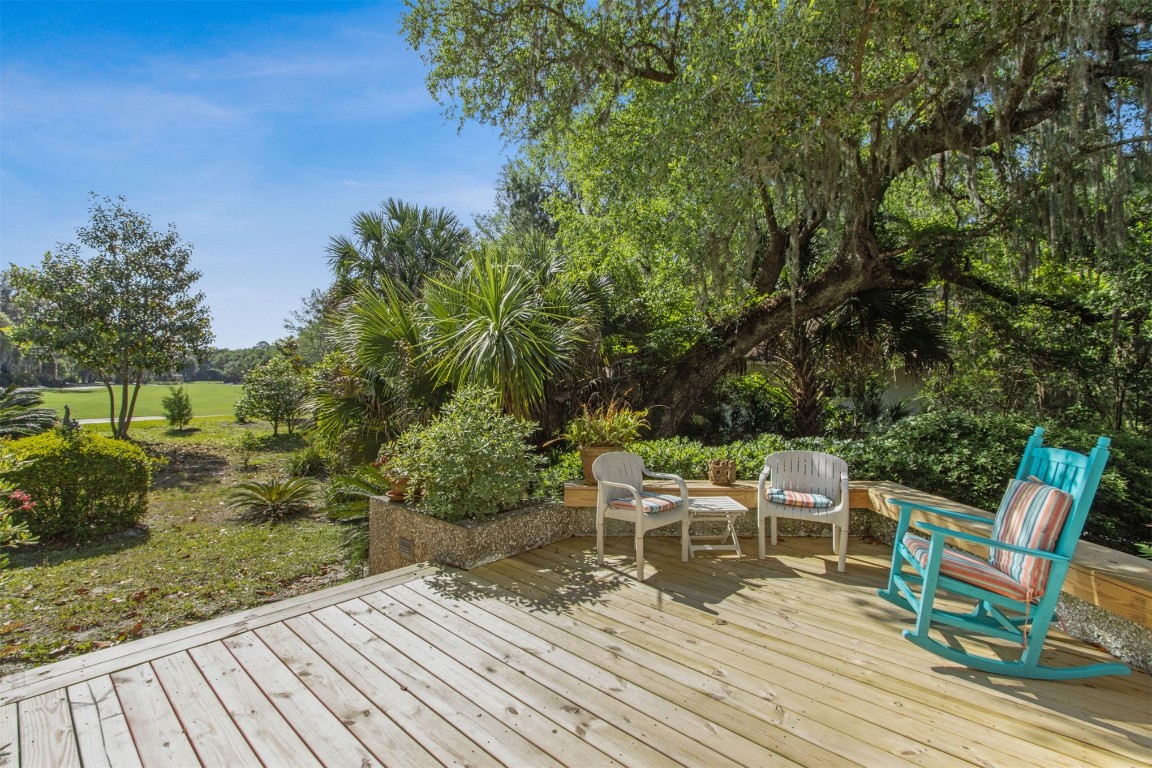 75 Marsh Creek Road Fernandina Beach, FL 32034 - Photo 31 of 42 a view of a chairs and table on the wooden deck