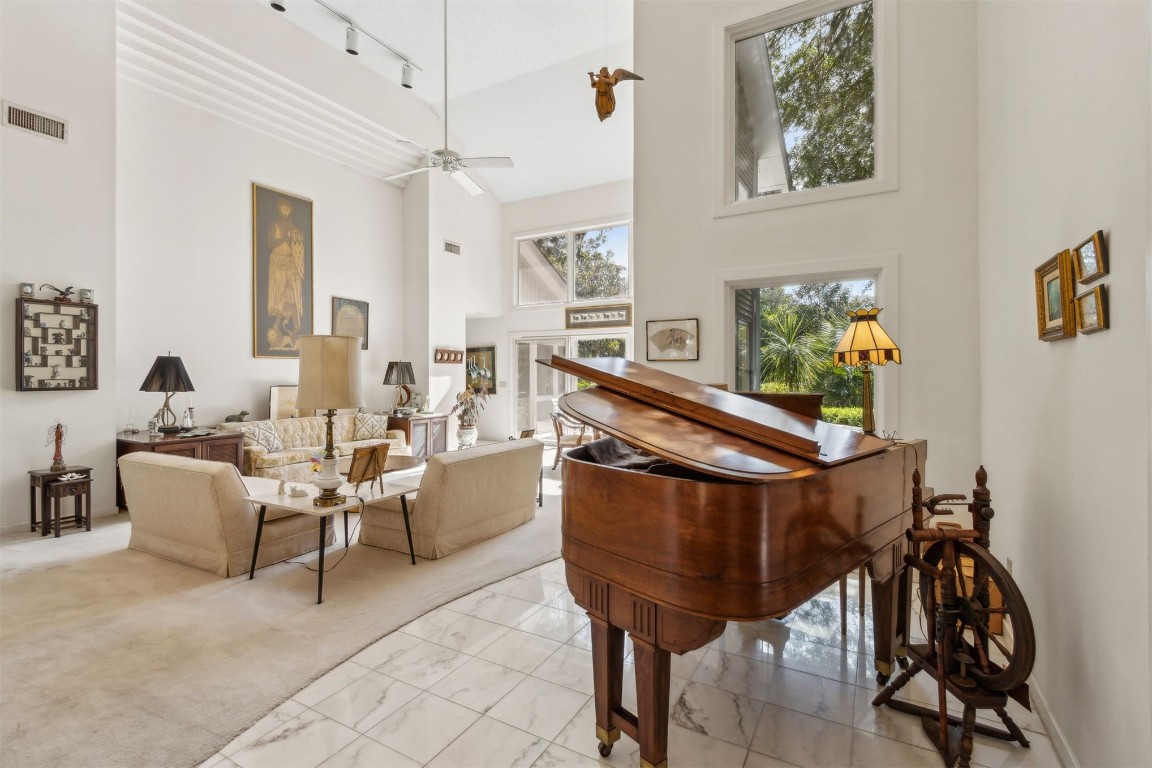 75 Marsh Creek Road Fernandina Beach, FL 32034 - Photo 5 of 42 a living room with furniture a rug and a chandelier