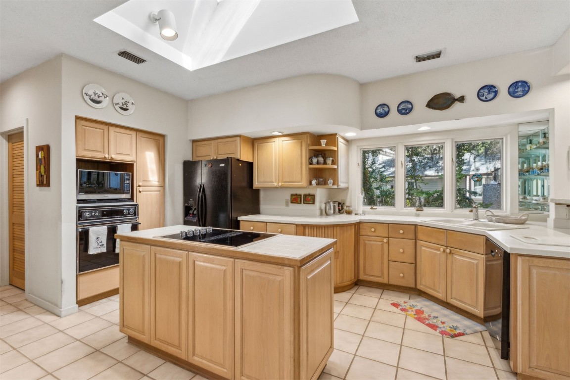 75 Marsh Creek Road Fernandina Beach, FL 32034 - Photo 10 of 42 a kitchen with stainless steel appliances granite countertop a stove and a sink