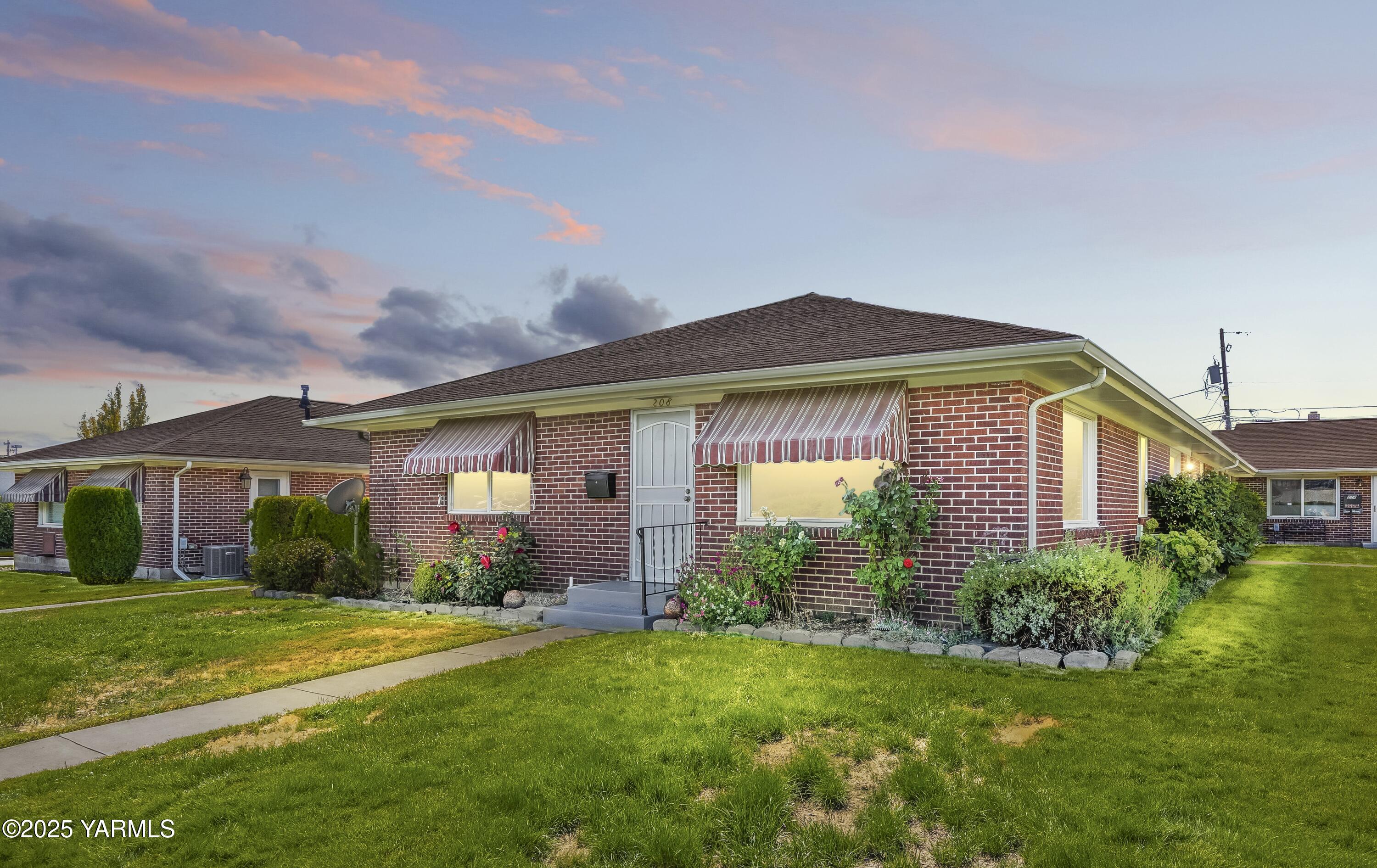 a front view of a house with garden