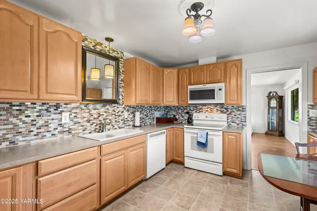 a kitchen with stainless steel appliances granite countertop a sink and a microwave
