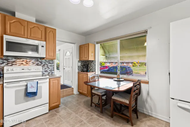 a kitchen with stainless steel appliances a stove a sink and a refrigerator