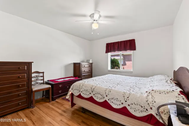 a bedroom with a bed dresser and a window