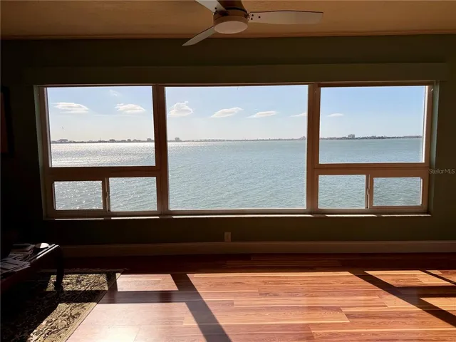 a bedroom with a bed couch and a window
