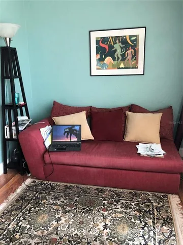 a view of a balcony with a chair and wooden floor