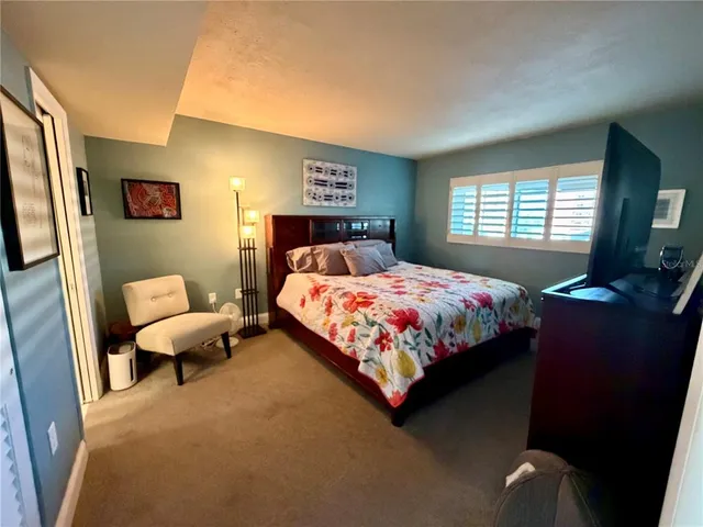 a bedroom with a large bed and a closet