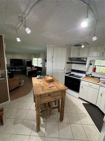 a kitchen with stainless steel appliances kitchen island granite countertop a sink and cabinets