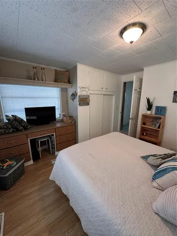 a bedroom with a bed and a television