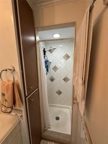 a bathroom with a glass door shower and a mirror