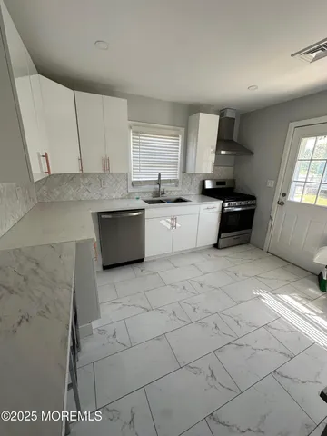 a kitchen with a sink cabinets and window