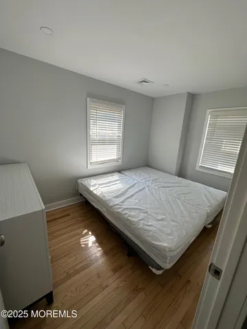 a bed sitting in a room next to a window