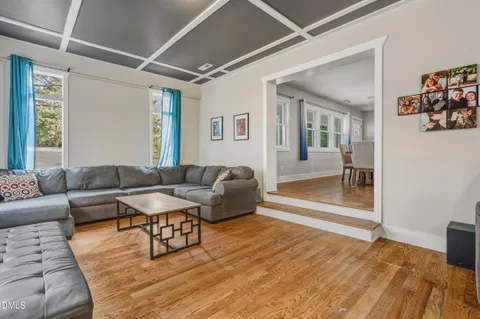 a living room with furniture a window and a flat screen tv